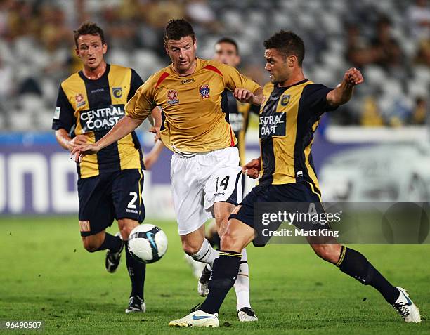 Michael Bridges of the Jets is challenged by Pedj Bojic of the Mariners during the round 26 A-League match between the Central Coast Mariners and the...