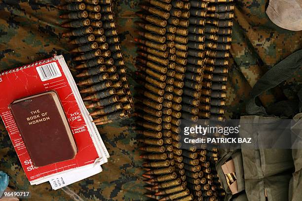 Book of Mormon" is seen among ammunition as US Marines with 1/3 Marines Alpha company check their equipment at a company operation base in Toor Ghar...