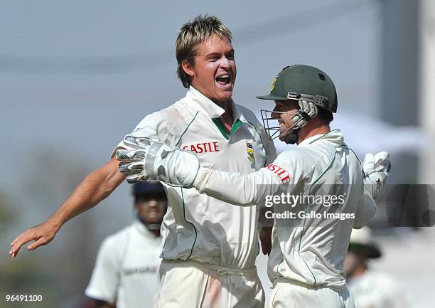 Paul Harris and Mark Boucher of South Africa celebrate the wicket of MS Dhoni of India for 6 runs during the day 3 of the 1st test between India and...