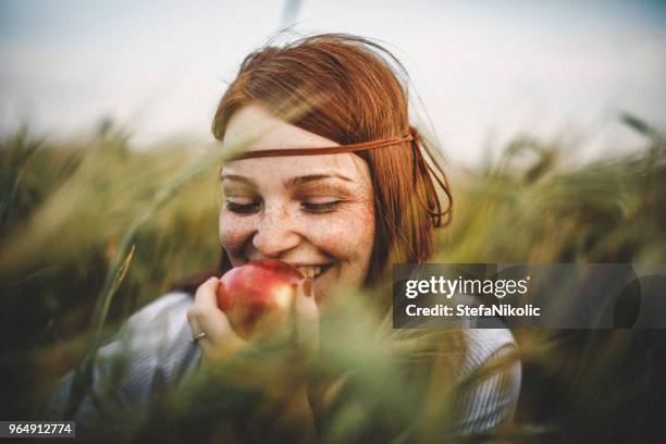 close-up portrait of young woman - apple face stock pictures, royalty-free photos & images