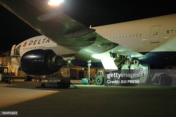 Delhi Airlines passenger jet sits on the tarmac after a dead body was found in the main landing gear bay of the fuselage at Narita international...