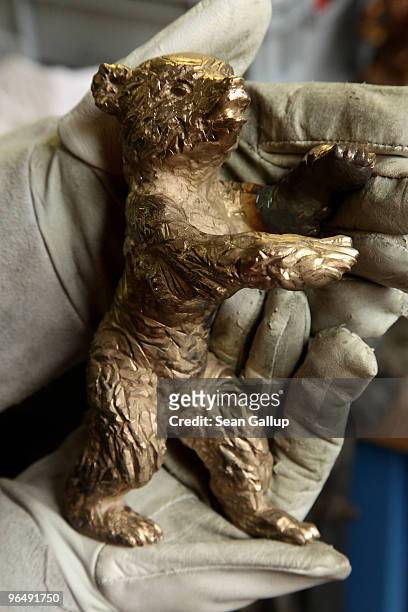 Berlinale Bear lies in the gloved hands of metal crafts worker Christiane Reum at the Hermann Noack casting foundry on February 8, 2010 in Berlin,...