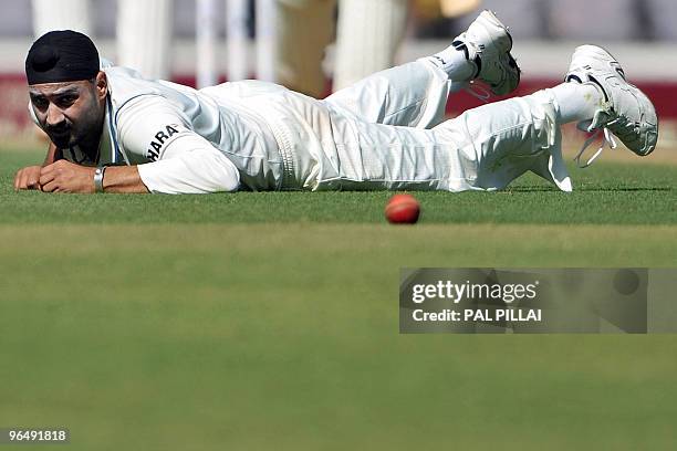 Indian cricketer Harbhajan Singh watches the ball as he misses it following a jump after bowling on the second day of the first cricket Test match...