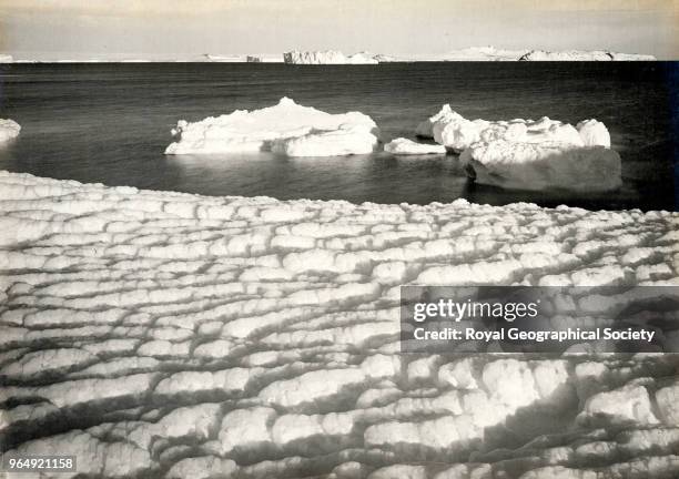 Weathered ice after blizzard at Cape Evans, looking to Castle Rock, Antarctica, 8th March 1911. British Antarctic Expedition 1910-1913.