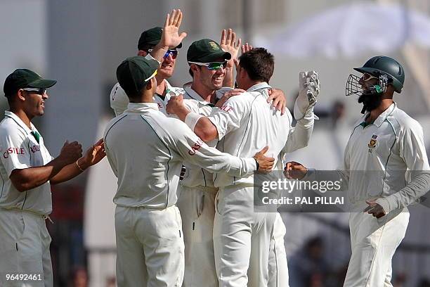 South African cricket captain Graeme Smith celebrates with teammates another Indian wicket on the third day of the first cricket Test match between...