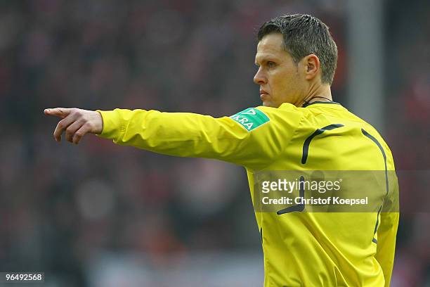 Referee Michael Weiner issues instructions during the Bundesliga match between 1. FC Koeln and Hamburger SV at the RheinEnergieStadion on February 6,...