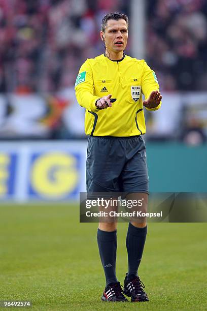 Referee Michael Weiner issues instructions during the Bundesliga match between 1. FC Koeln and Hamburger SV at the RheinEnergieStadion on February 6,...