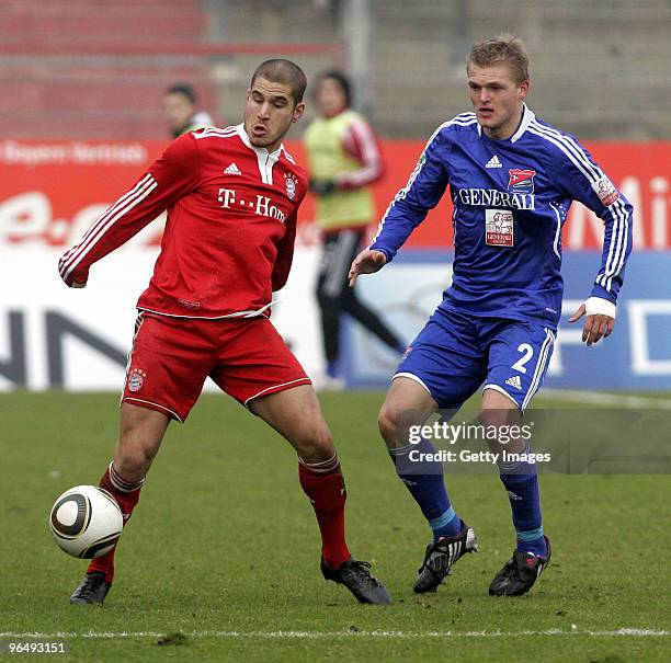 Deniz Yilmaz of Bayern II and Thorsten Schulz of Unterhaching battle for the ball during the 3.Liga match between SpVgg Unterhaching and Bayern...