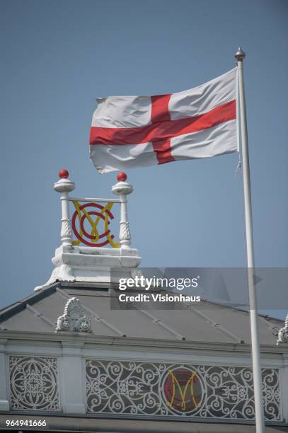 The flag of St.George flies over the MCC crest on the pavillion of the Marylebone Cricket Club during Day Three of the 1st NatWest Test Match between...