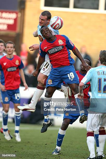 Andy Holt of Northampton Town challenges for the ball with Abu Ogogo of Dagenham & Redbridge during the Coca Cola League Two Match between Dagenham &...