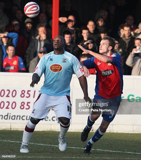 Adebayo Akinfenwa of Northampton Town looks for the ball with Scott Doe of Dagenham & Redbridge during the Coca Cola League Two Match between...