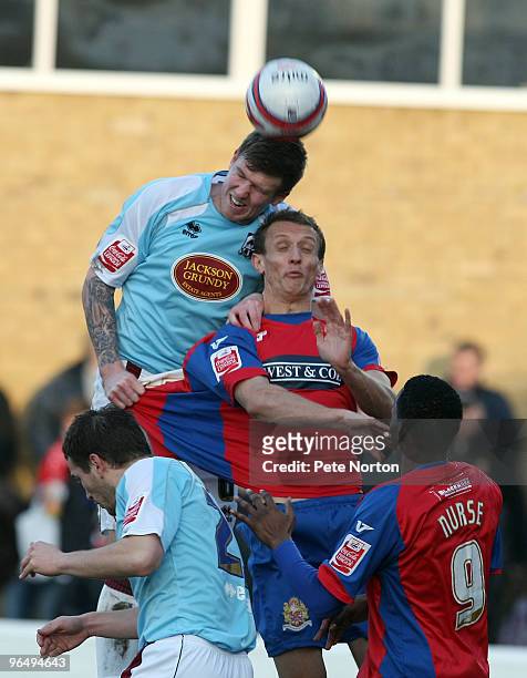 Dean Beckwith of Northampton Town rises above Paul Benson of Dagenham & Redbridge to head the ball during the Coca Cola League Two Match between...