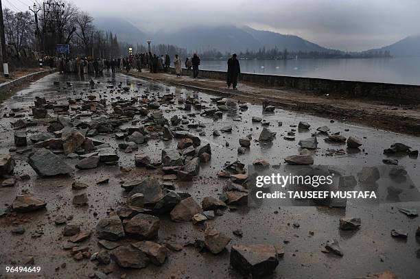 Mourning Kashmiris block a road near the body of Zahid Farooq who died on February 5, 2010 after an altercation broke-out between troops and a group...