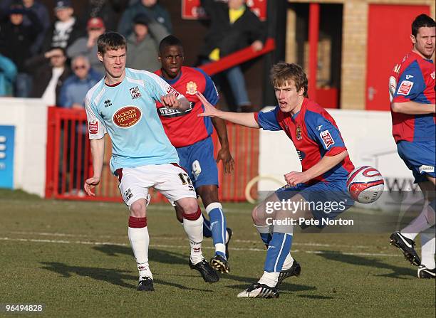 Billy McKay of Northampton Town plays the ball watched by Damien McCrory of Dagenham & Redbridge during the Coca Cola League Two Match between...