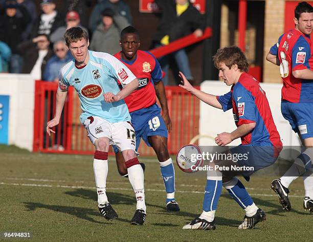 Billy McKay of Northampton Town plays the ball watched by Damien McCrory of Dagenham & Redbridge during the Coca Cola League Two Match between...