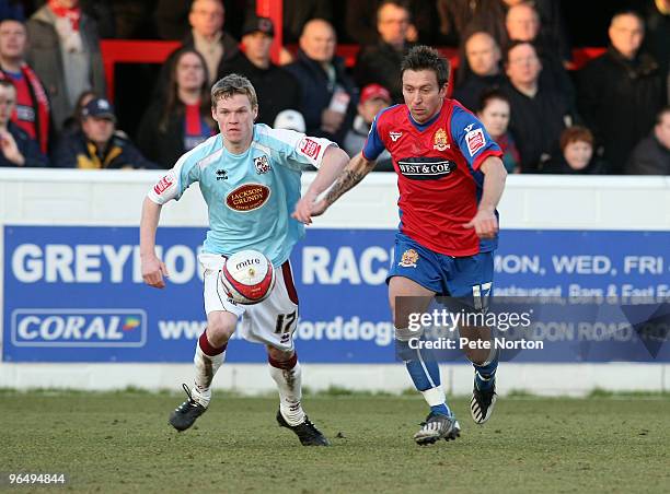 Billy McKay of Northampton Town challenges for the ball with Darren Currie of Dagenham & Redbridge during the Coca Cola League Two Match between...