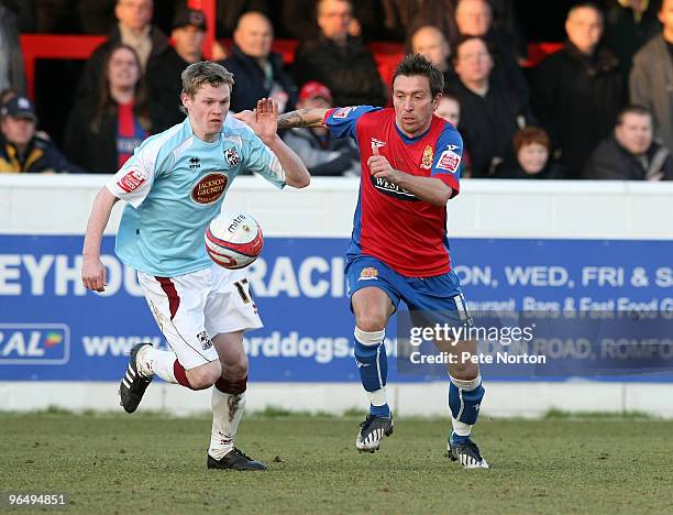 Billy McKay of Northampton Town challenges for the ball with Darren Currie of Dagenham & Redbridge during the Coca Cola League Two Match between...