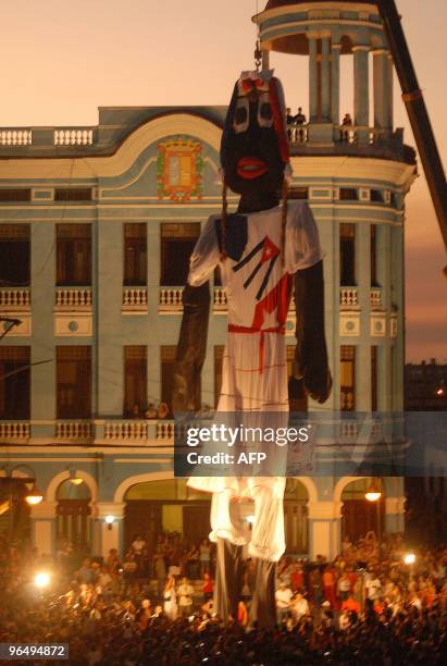 An 18-meter rag doll is held up by a crane in the central park of Camaguey, Cuba on February 3, 2010. The rag doll hopes to win the Guinness record....