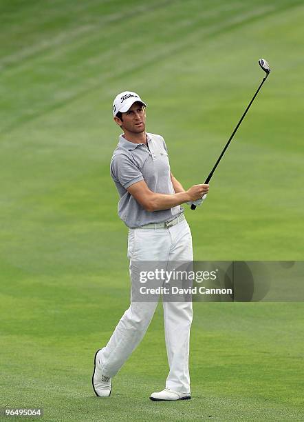 Gregory Bourdy of France plays his second shot at the 12th hole during the final round of the 2010 Omega Dubai Desert Classic on the Majilis Course...