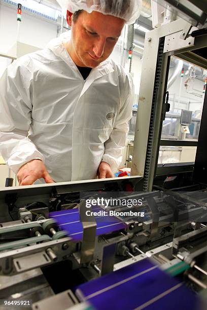 Employee Carsten Klose controls a solar wafer machine at the Solarworld AG plant in Freiberg, Germany, on Monday, Feb. 8, 2010. Germany's solar...