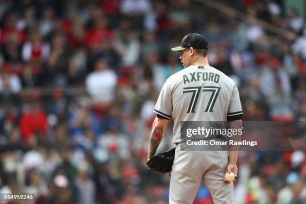 John Axford of the Toronto Blue Jays pitches in the bottom of the seventh inning of the game against the Boston Red Sox at Fenway Park on May 28,...