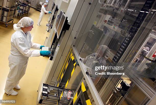Employee Kerstin Kluth controls a solar wafer machine at the Solarworld AG plant in Freiberg, Germany, on Monday, Feb. 8, 2010. Germany's solar...