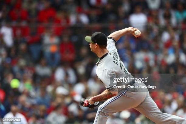 John Axford of the Toronto Blue Jays pitches in the bottom of the seventh inning of the game against the Boston Red Sox at Fenway Park on May 28,...