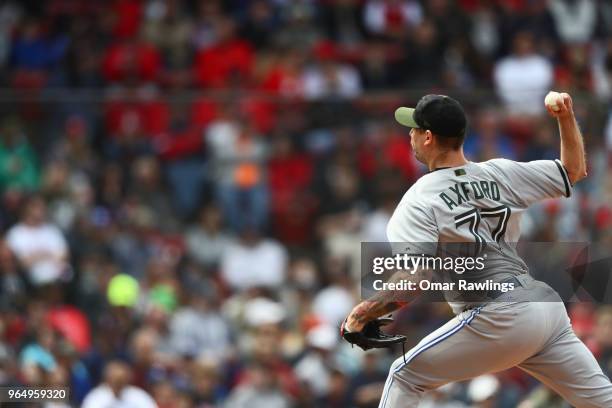 John Axford of the Toronto Blue Jays pitches in the bottom of the seventh inning of the game against the Boston Red Sox at Fenway Park on May 28,...