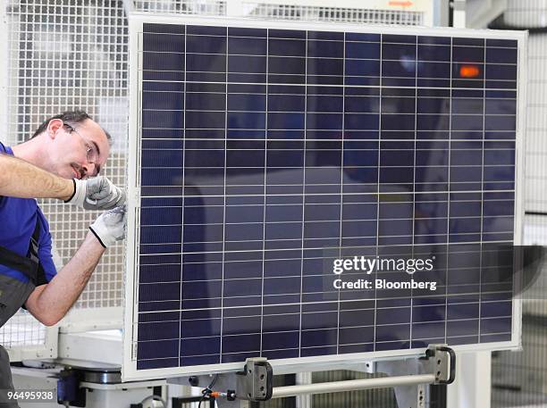 Employee Olaf Eberlein assembles a solar panel at the Solarworld AG plant in Freiberg, Germany, on Monday, Feb. 8, 2010. Germany's solar industry...
