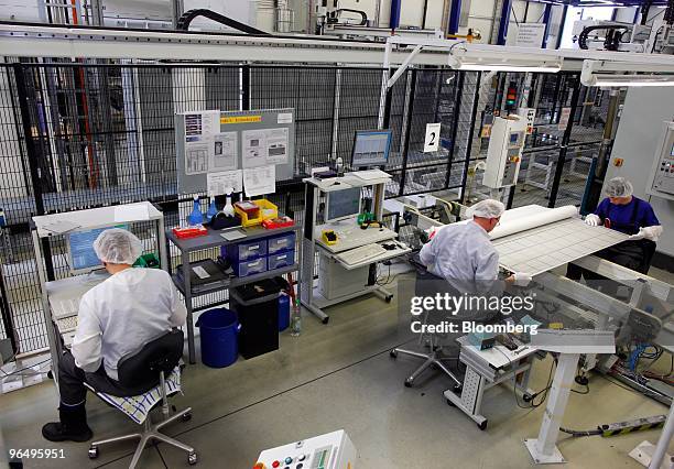 Employees work at the Solarworld AG plant in Freiberg, Germany, on Monday, Feb. 8, 2010. Germany's solar industry said the government's proposed...