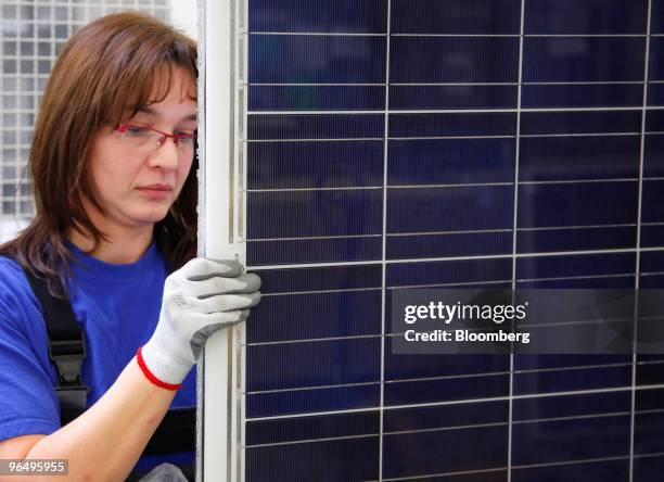 Employee Jana Boehme inspects solar panels at the Solarworld AG plant in Freiberg, Germany, on Monday, Feb. 8, 2010. Germany's solar industry said...