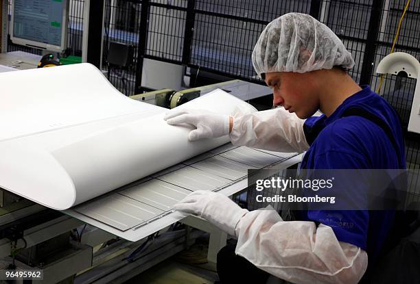 Benjamin Berger inspects solar wafers at the Solarworld AG plant in Freiberg, Germany, on Monday, Feb. 8, 2010. Germany's solar industry said the...