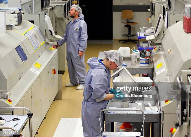 Employees work at the Solarworld AG plant in Freiberg, Germany, on Monday, Feb. 8, 2010. Germany's solar industry said the government's proposed...