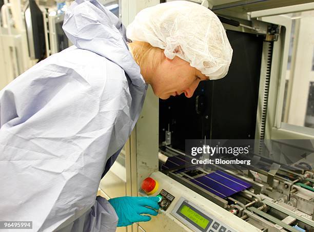 Employee Kerstin Kluth controls a solar wafer machine at the Solarworld AG plant in Freiberg, Germany, on Monday, Feb. 8, 2010. Germany's solar...