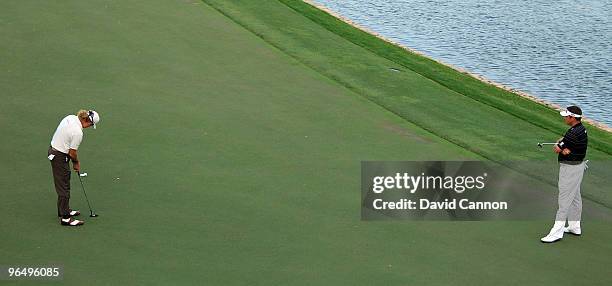 Lee Westwood of England watches as Miguel Angel Jimenez of Spain holes his putt to beat Westwood at the third extra hole during the final round of...