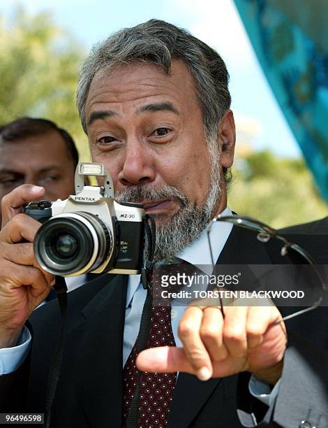 East Timorese President Xanana Gusmao pulls a face as he takes photos of delegates leaving the official opening ceremony for the 3rd African,...