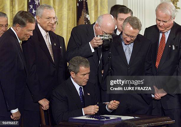 President George W. Bush signs into law an anti-terrorism bill that expands police and surveillance powers in response to September 11 attacks on the...