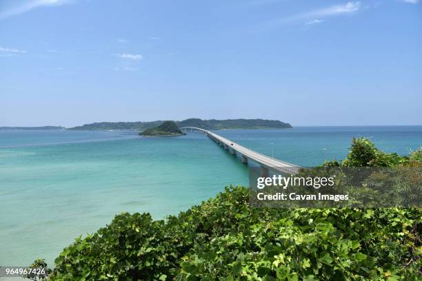 high angle view of tsunoshima ohashi bridge over sea against sky - yamaguchi stock pictures, royalty-free photos & images