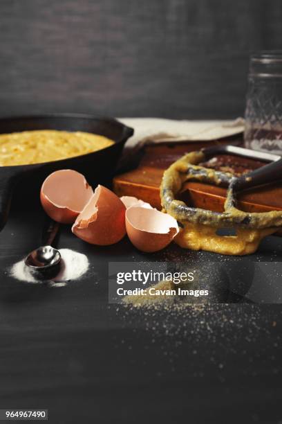 close-up of messy kitchen counter with broken eggshells and kitchen utensils - close up counter ストックフォトと画像