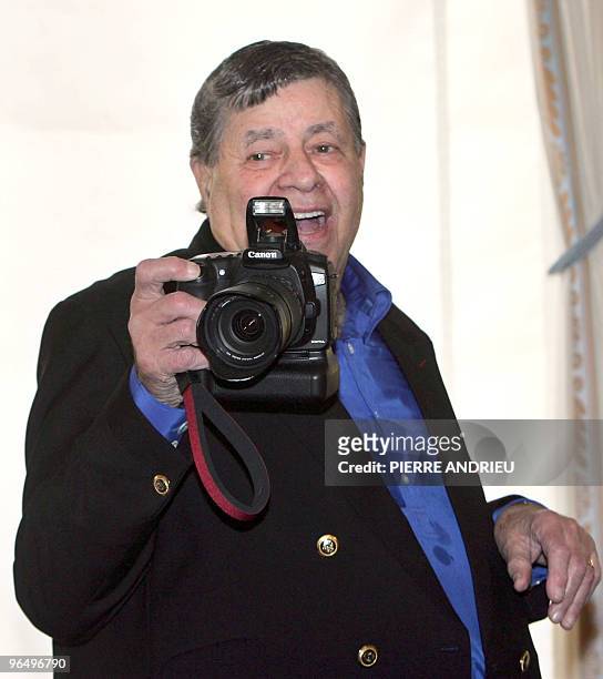 Actor Jerry Lewis takes a picture after being awarded the French Legion d'Honneur by French Culture Minister Renaud Donnedieu de Vabres, at the...
