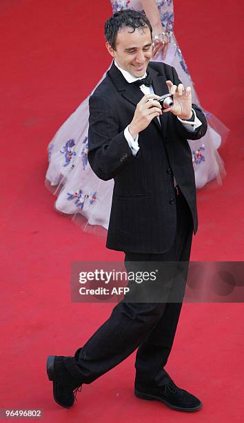 French stand-up comedian and singer Elie Semoun takes pictures as he arrives for the screening of US director George Lucas' film "Star Wars : Episode...