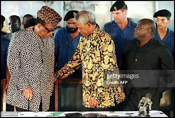 South African President Nelson Mandela helps airean President Mobutu Sese Seko as rebel leader Laurent-Desire Kabila looks on prior to a press...