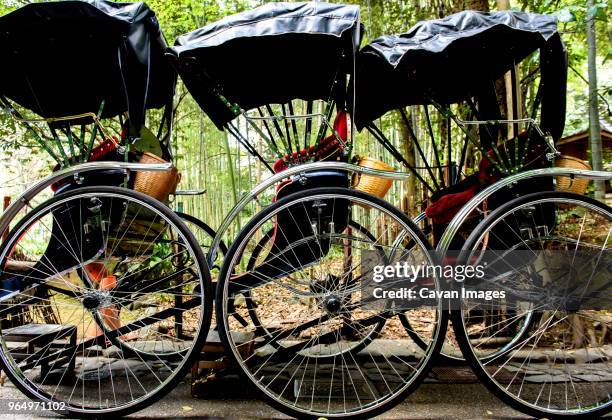 jinrikisha parked side by side on road - three wheel rickshaw stock pictures, royalty-free photos & images