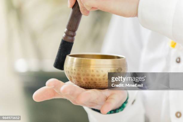 man practicing kundalini yoga and meditation with a singing bowl - gong stock pictures, royalty-free photos & images