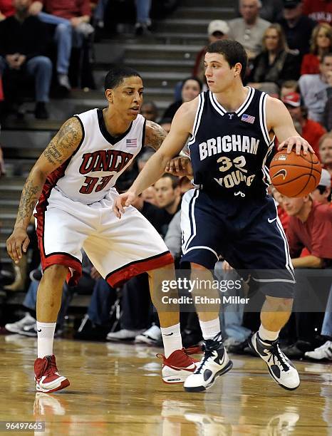 Jimmer Fredette of the Brigham Young University Cougars drives against Tre'Von Willis of the UNLV Rebels during the game at the Thomas & Mack Center...