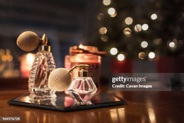 close-up of perfume sprayers on wooden table - parfum stock pictures, royalty-free photos & images