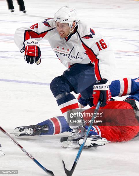 Eric Fehr of the Washington Capitals jumps over his opponent on the New York Rangers in the second period on February 4, 2010 at Madison Square...
