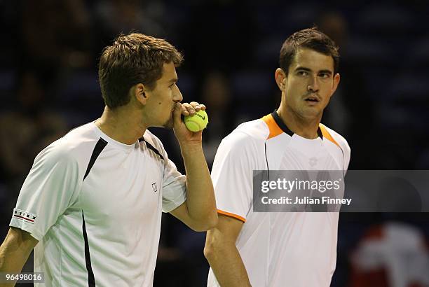 Marco Chiudinelli of Switzerland and Guillermo Garcia-Lopez of Spain talk tactics in their doubles match against Marcin Matkowski and Mariusz...