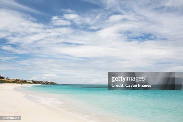 scenic view of sea against cloudy sky on sunny day - anguilla photos et images de collection