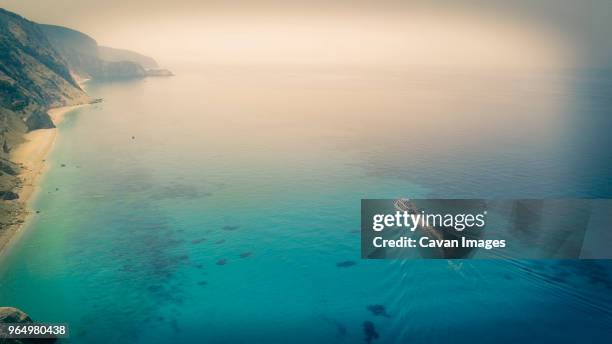high angle view of boat sailing in sea by egremni beach - egremni stock pictures, royalty-free photos & images